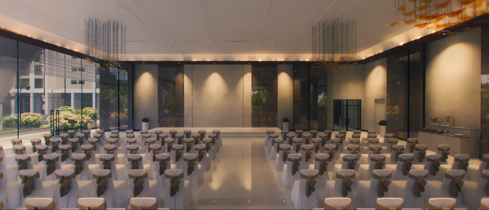 The banquet hall set up with rows of chairs facing the stage