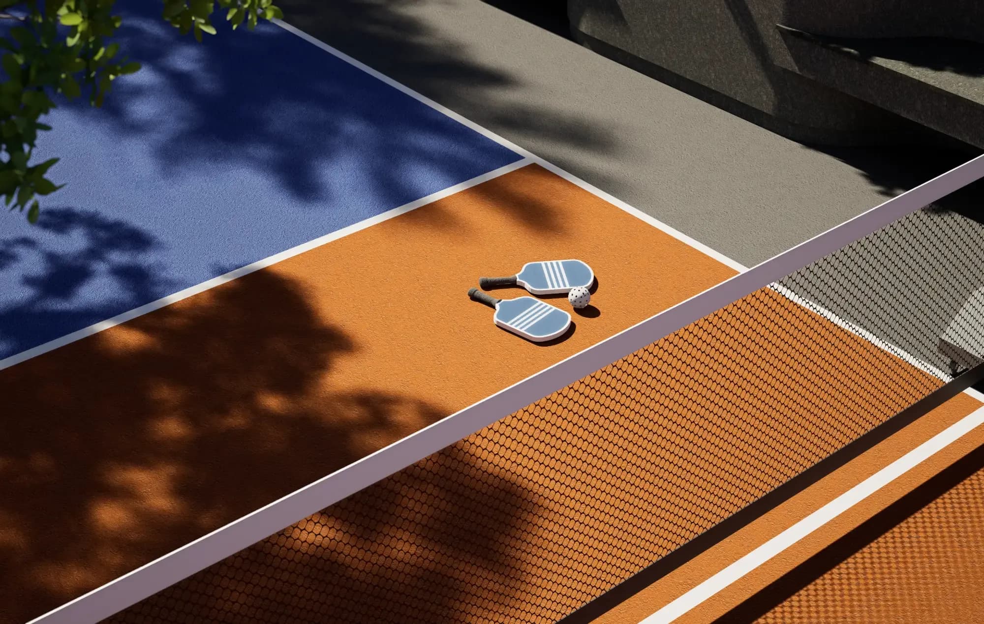 Pickleball paddles and ball on the orange and blue court