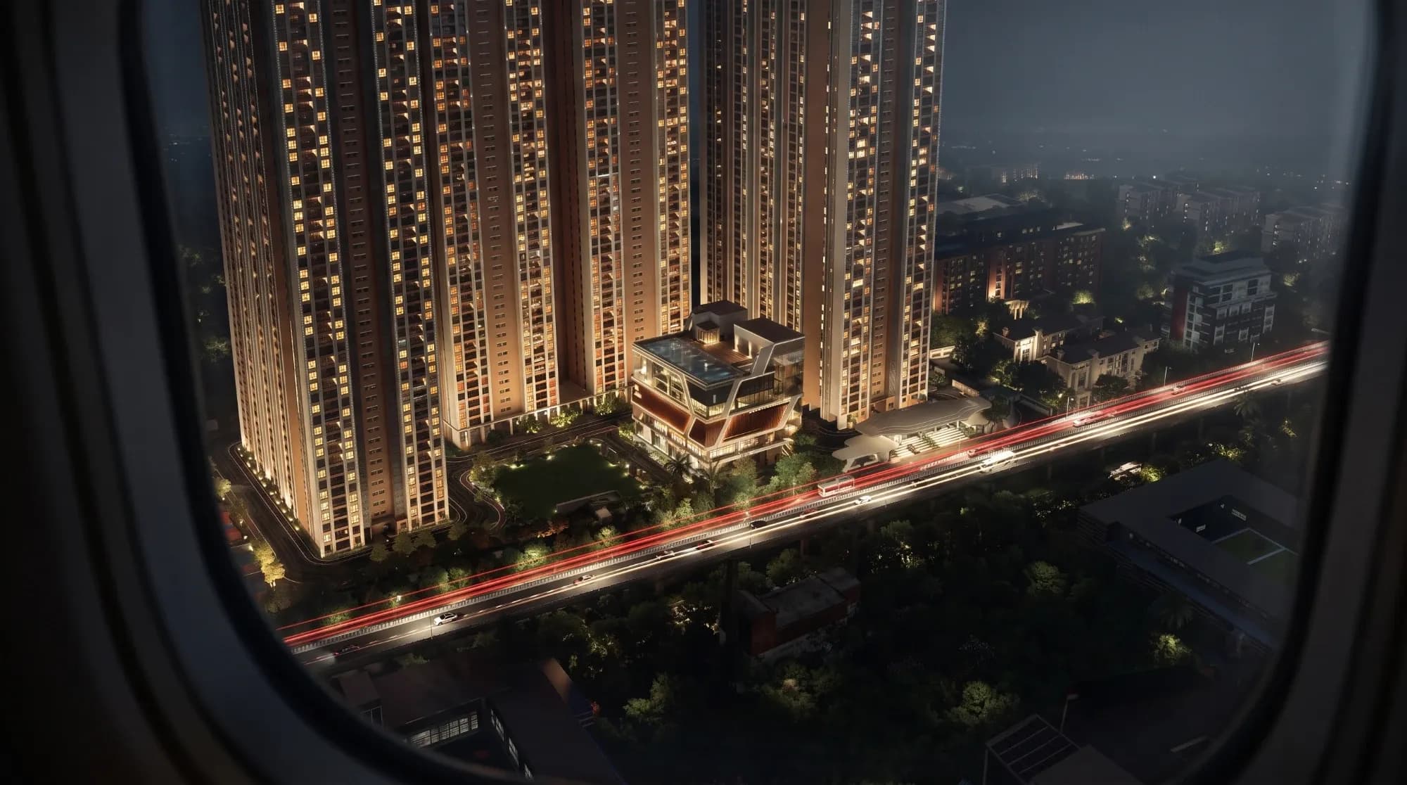 Night aerial view of the ASBL Legacy towers and the clubhouse with its rooftop pool